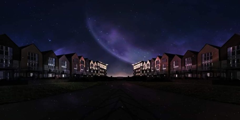 Night scene of houses under a dramatic sky with purple hues and a large celestial body.