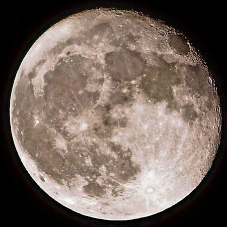 A detailed view of the full moon with visible craters and surface textures.